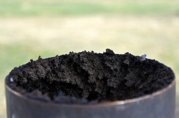 Chimney flue pipe covered with a thick layer of soot.